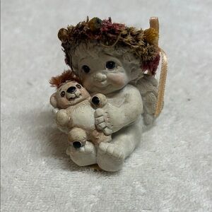 A vintage Dreamsicles 'Teddy And Me' cherub figurine holding a teddy bear.